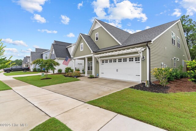 3763 Spicetree Dr, Wilmington, NC 28412 - view of front of property with board and batten siding, a garage, a front lawn, a shingled roof, and driveway