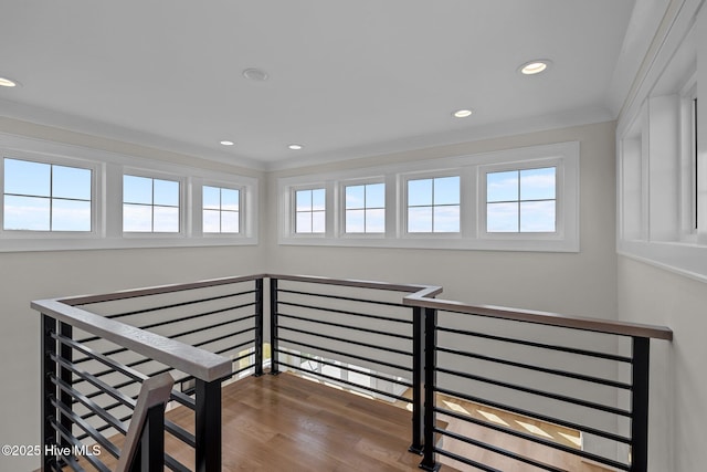 staircase with crown molding, wood finished floors, and recessed lighting