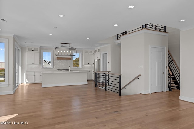unfurnished living room featuring recessed lighting and light wood-style floors