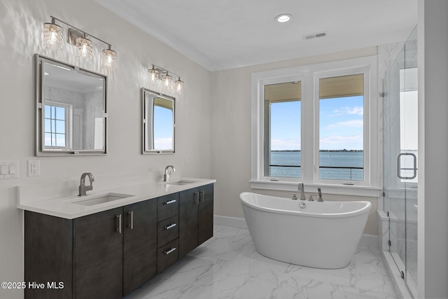 bathroom with marble finish floor, baseboards, a sink, and visible vents