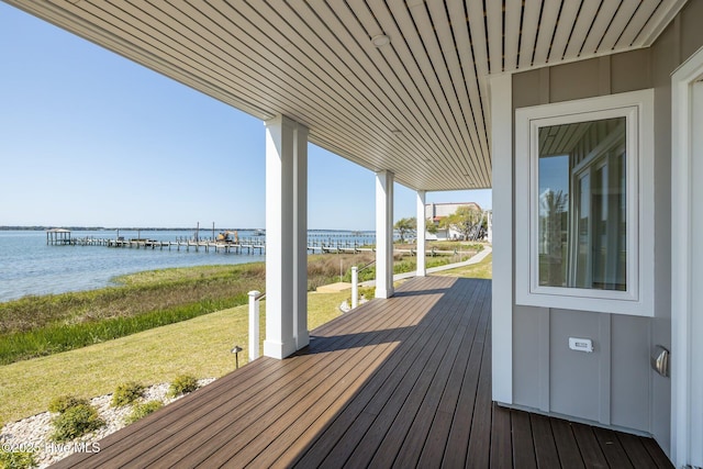 deck featuring a yard and a water view