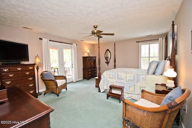 511 Pine Valley Dr, Morehead City, NC 28557 - carpeted bedroom featuring access to outside, a textured ceiling, baseboards, and a ceiling fan