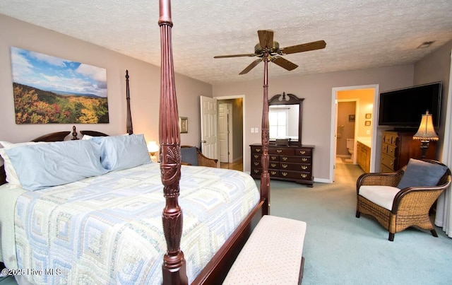 511 Pine Valley Dr, Morehead City, NC 28557 - bedroom featuring light carpet, a textured ceiling, ensuite bathroom, ceiling fan, and baseboards