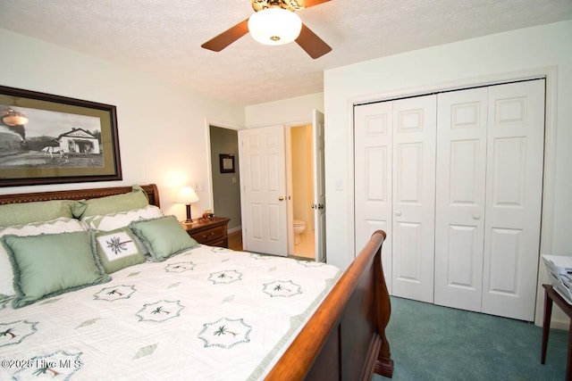511 Pine Valley Dr, Morehead City, NC 28557 - bedroom featuring a closet, dark carpet, a textured ceiling, and a ceiling fan