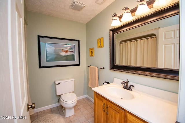 511 Pine Valley Dr, Morehead City, NC 28557 - bathroom with toilet, baseboards, vanity, tile patterned flooring, and a textured ceiling