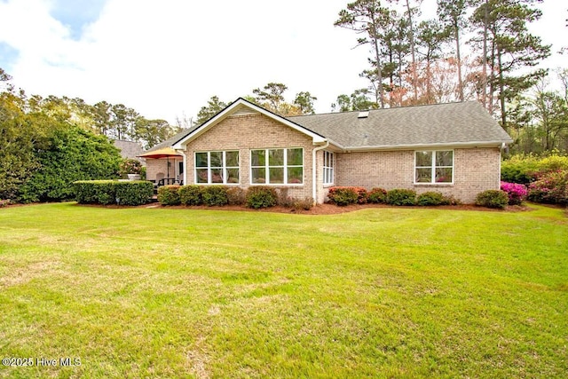 511 Pine Valley Dr, Morehead City, NC 28557 - back of property featuring brick siding, a yard, and a shingled roof