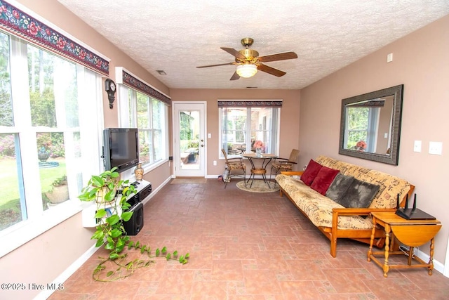 511 Pine Valley Dr, Morehead City, NC 28557 - living room with baseboards, ceiling fan, and a textured ceiling