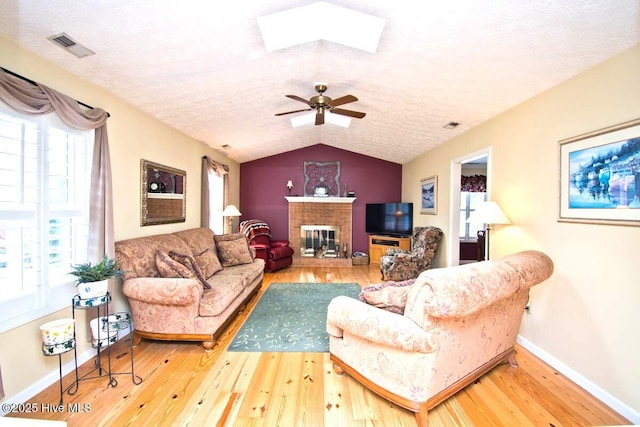 511 Pine Valley Dr, Morehead City, NC 28557 - living area featuring wood-type flooring, baseboards, a skylight, vaulted ceiling, and plenty of natural light