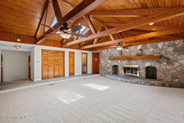 unfurnished living room with a fireplace, a ceiling fan, beam ceiling, carpet, and wooden ceiling