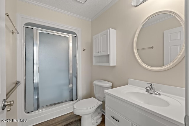 full bath featuring toilet, a stall shower, vanity, and ornamental molding