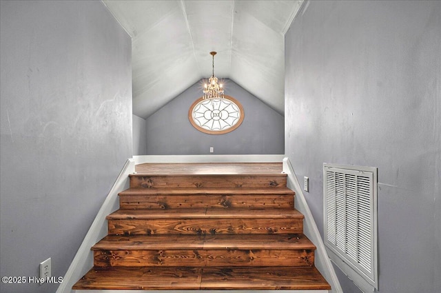 staircase featuring visible vents and vaulted ceiling