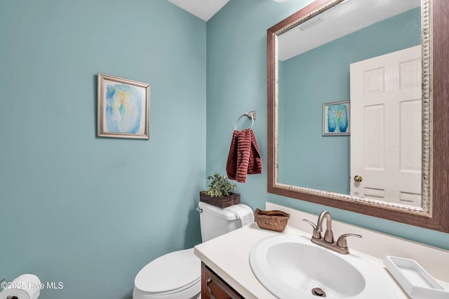 bathroom featuring toilet and vanity