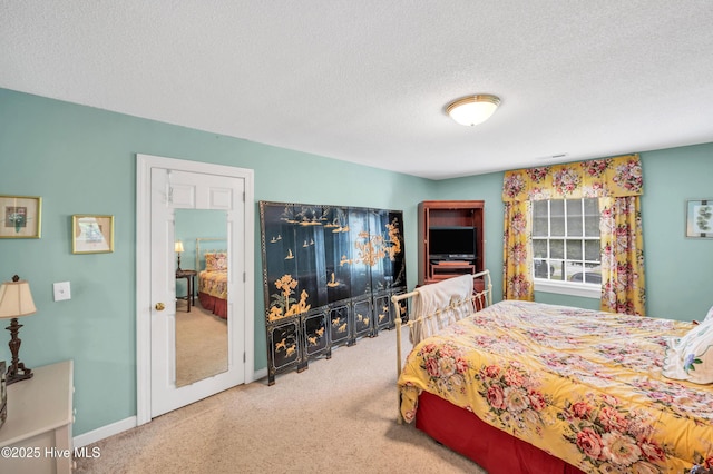 carpeted bedroom featuring a textured ceiling