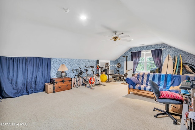 rec room featuring carpet flooring, vaulted ceiling, a ceiling fan, and wallpapered walls