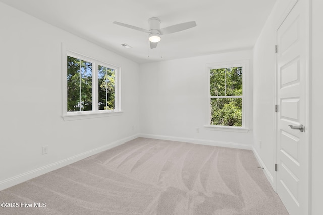 341 Mccabe Rd, Morehead City, NC 28557 - spare room with ceiling fan, light carpet, baseboards, and visible vents