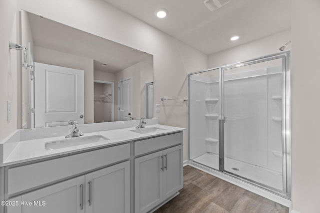 409 King Creek Dr, Havelock, NC 28532 - bathroom featuring a shower stall, double vanity, wood finished floors, a spacious closet, and recessed lighting