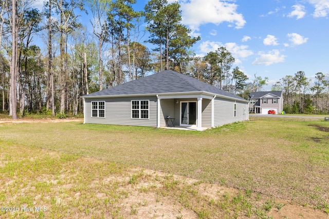 409 King Creek Dr, Havelock, NC 28532 - back of property featuring a lawn and a patio area