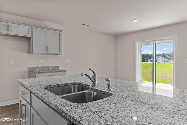 409 King Creek Dr, Havelock, NC 28532 - kitchen with light stone counters, gray cabinets, dark wood-style flooring, and recessed lighting