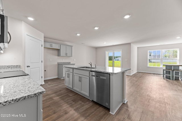 409 King Creek Dr, Havelock, NC 28532 - kitchen featuring stainless steel appliances, dark wood-style floors, gray cabinetry, a kitchen island with sink, and light stone countertops