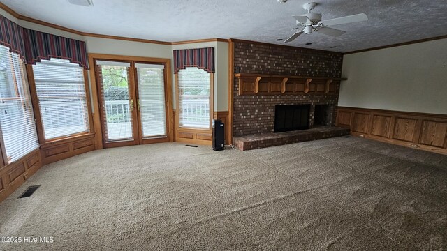 112 Reynard Path, Clinton, NC 28328 - unfurnished living room featuring crown molding, visible vents, and a wainscoted wall