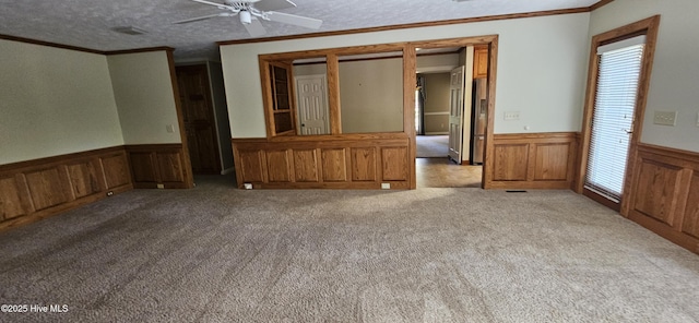 112 Reynard Path, Clinton, NC 28328 - unfurnished living room featuring ornamental molding, carpet, and a wainscoted wall