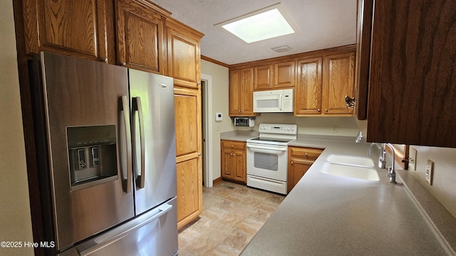 112 Reynard Path, Clinton, NC 28328 - kitchen featuring white appliances, brown cabinetry, visible vents, a sink, and light countertops