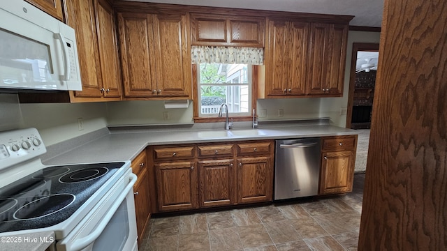 112 Reynard Path, Clinton, NC 28328 - kitchen with brown cabinetry, white appliances, light countertops, and a sink