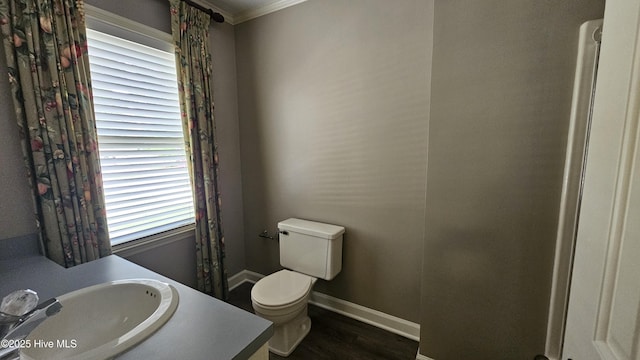 112 Reynard Path, Clinton, NC 28328 - bathroom with crown molding, vanity, toilet, wood finished floors, and baseboards