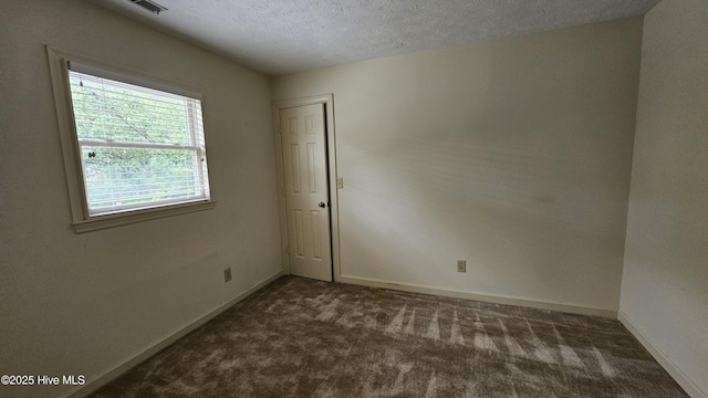 112 Reynard Path, Clinton, NC 28328 - unfurnished room with a textured ceiling, dark colored carpet, and baseboards