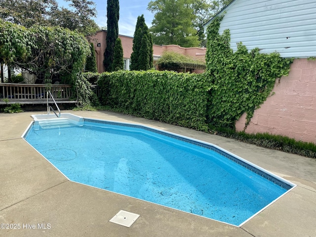 view of swimming pool featuring a fenced in pool