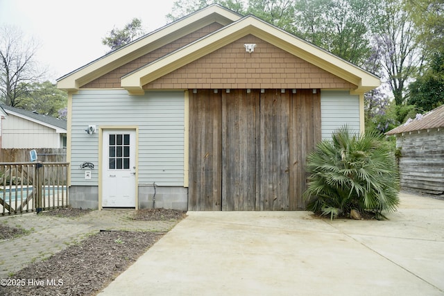 view of outbuilding featuring a fenced in pool and fence