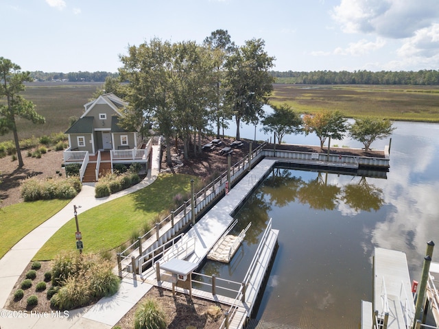 dock area with a yard and a water view