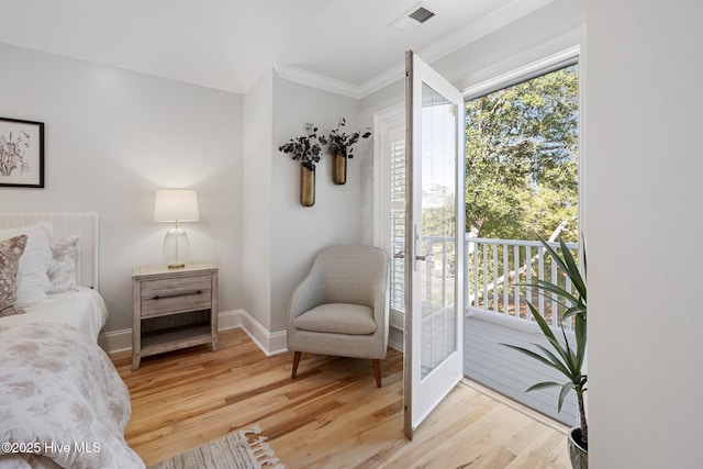 bedroom with crown molding, light wood-type flooring, baseboards, access to exterior, and visible vents