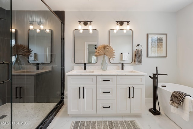 bathroom with marble finish floor, a freestanding bath, double vanity, a sink, and a stall shower