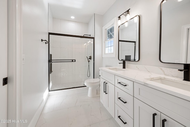 bathroom featuring marble finish floor, double vanity, toilet, a sink, and a stall shower