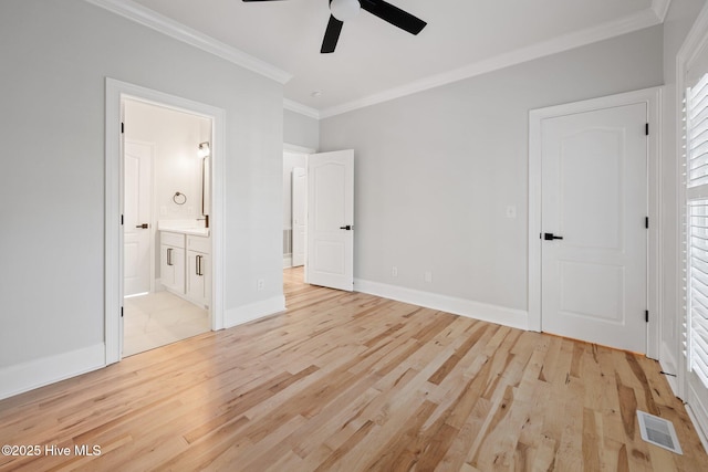unfurnished bedroom featuring light wood-style flooring, baseboards, visible vents, crown molding, and connected bathroom