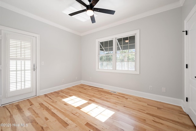 unfurnished room featuring ceiling fan, baseboards, wood finished floors, and ornamental molding