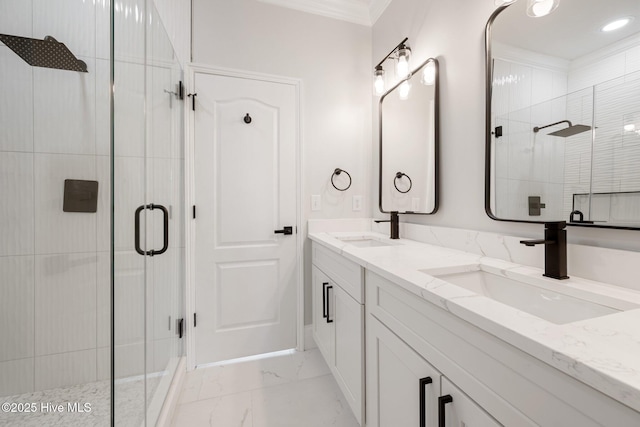bathroom featuring marble finish floor, a sink, a shower stall, and double vanity