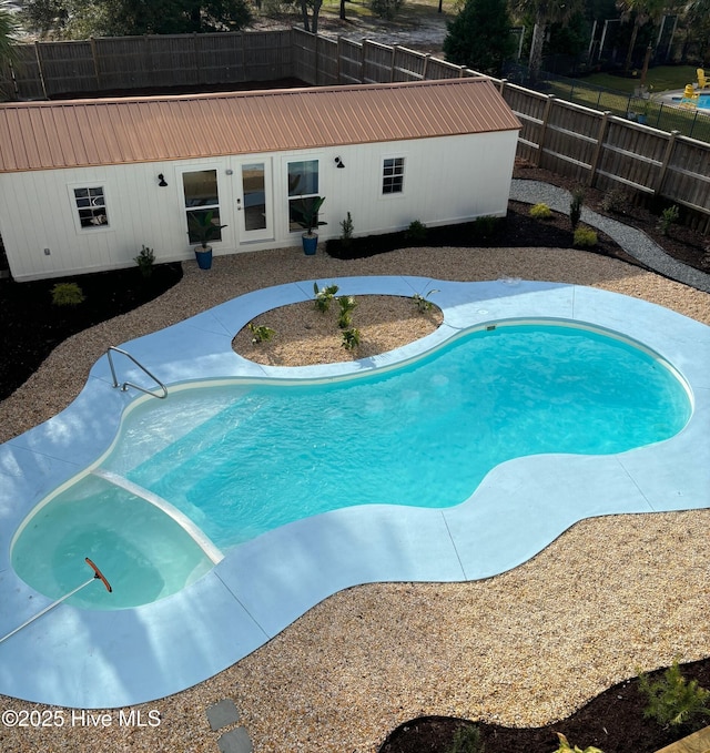 view of pool with a fenced in pool and fence