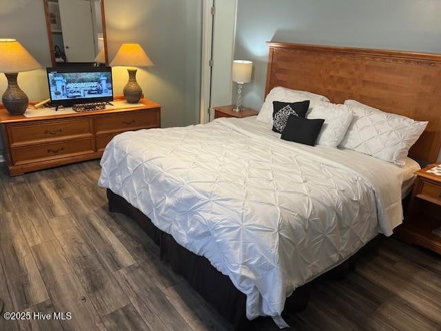 bedroom with dark wood finished floors