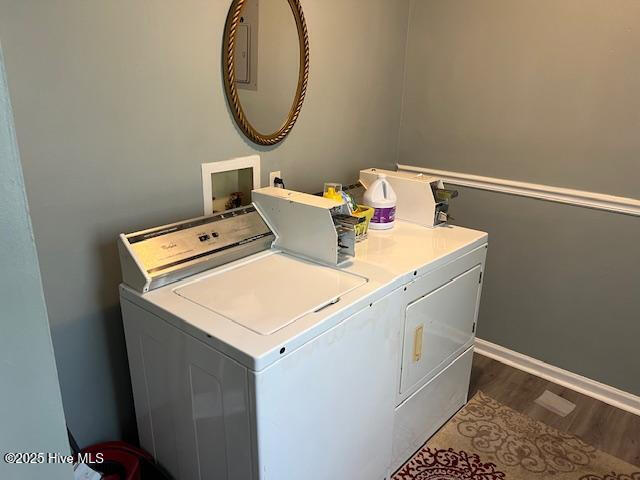 laundry area featuring baseboards, dark wood-style floors, laundry area, and washer and dryer