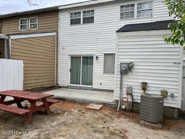 back of house featuring central AC unit, fence, and a patio