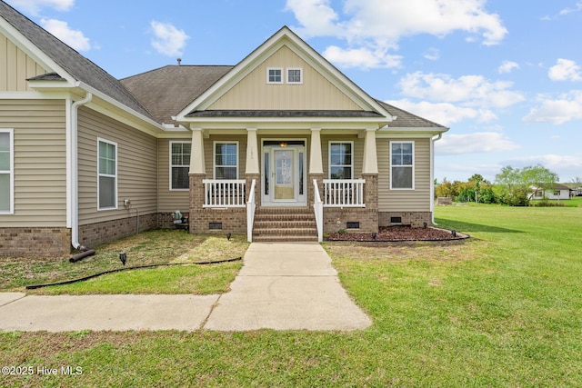 craftsman house with a front yard, a porch, crawl space, and roof with shingles