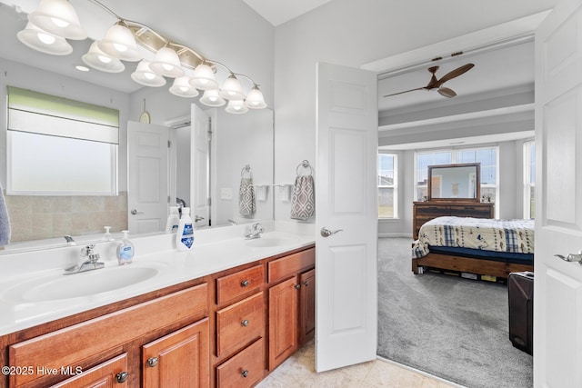 ensuite bathroom featuring a sink, tile patterned flooring, double vanity, and ensuite bath