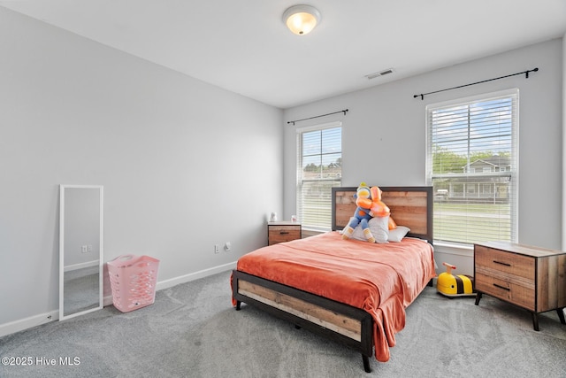 bedroom with carpet, visible vents, and baseboards
