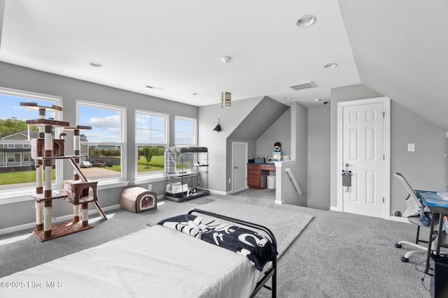 bedroom featuring carpet floors, baseboards, vaulted ceiling, and visible vents