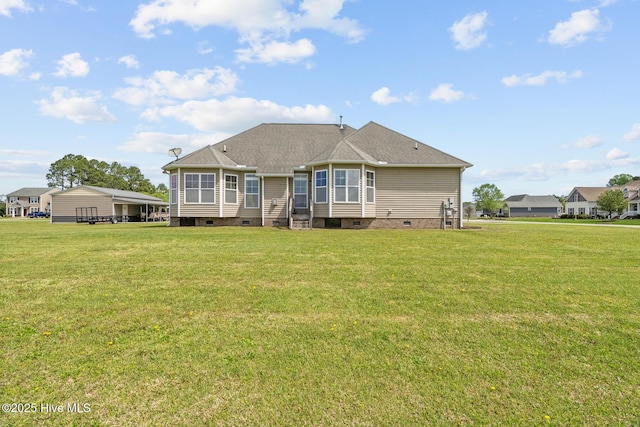 back of house featuring a yard, crawl space, and roof with shingles