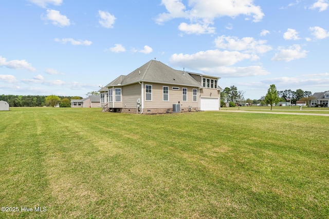 back of property featuring crawl space, an attached garage, central air condition unit, and a yard