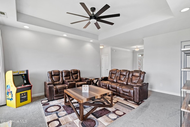 living area with baseboards, a ceiling fan, a tray ceiling, carpet floors, and recessed lighting