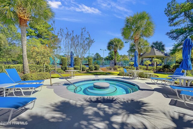 6865 Beckman Cir SW Unit 53, Ocean Isle Beach, NC 28469 - community pool with a patio, a gazebo, and view of wooded area